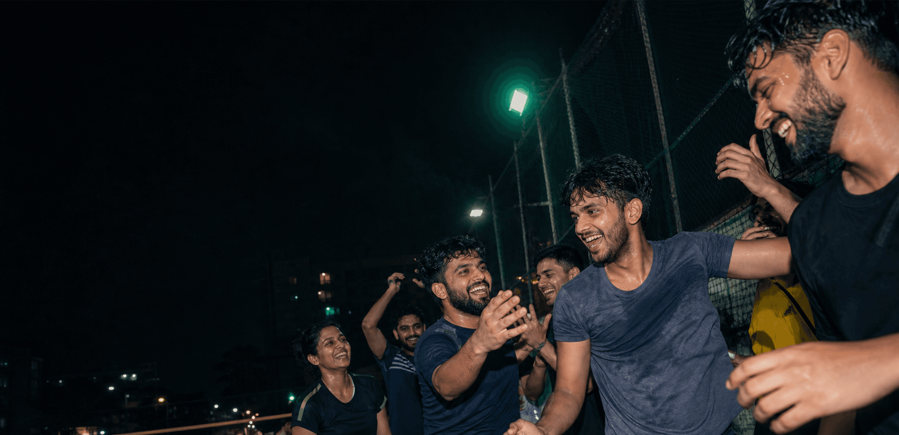 Friends celebrating after an evening game at a recreation arena